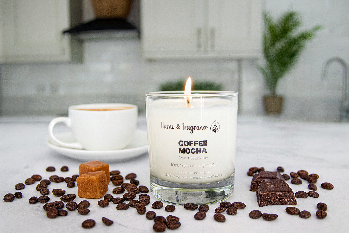 Candle labeled 'Coffee Mocha' with coffee beans, chocolate, and a cup on a kitchen counter.