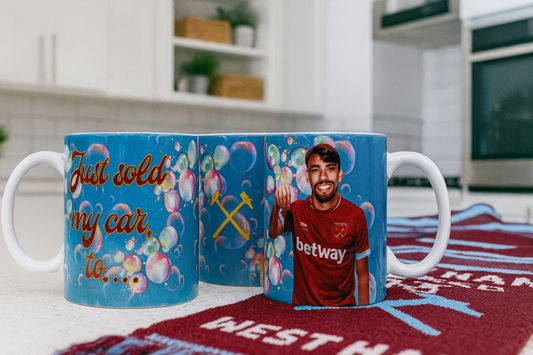 Coffee Mug with Lucas Paqueta in a West Ham home shirt on a surface with a kitchen background.