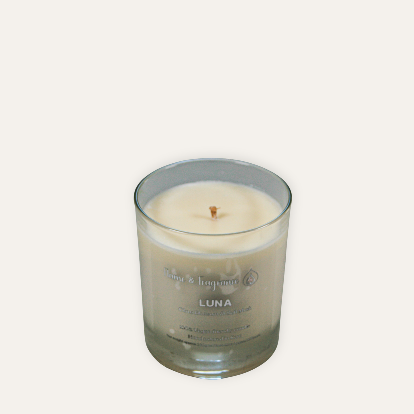 Glass candle with 'Luna' branding on a white background
