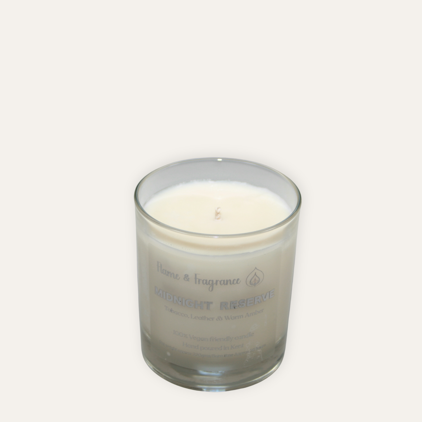 Glass candle with a label named 'Midnight Reserve' on a white background
