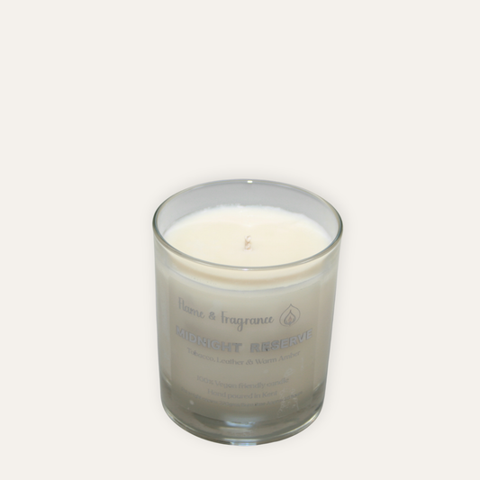 Glass candle with a label named 'Midnight Reserve' on a white background