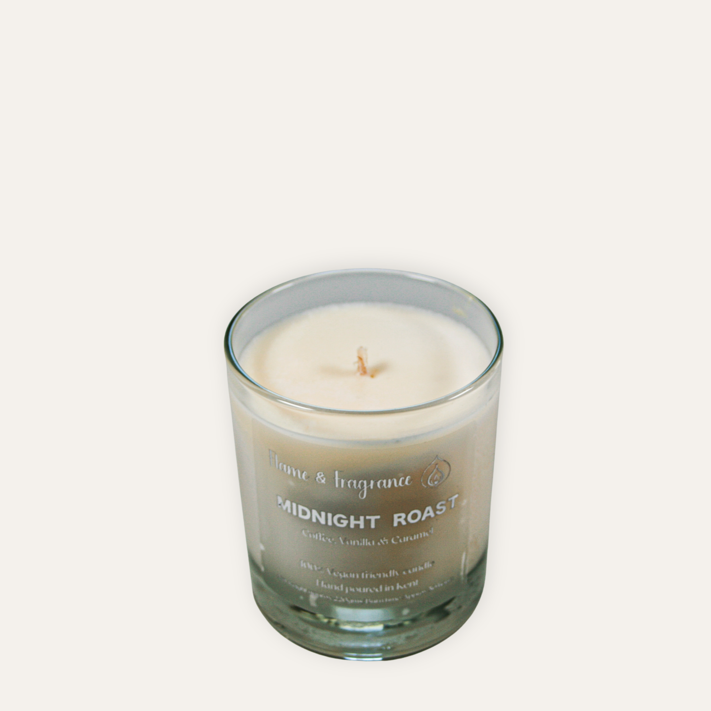 Candle in a glass jar labeled 'Midnight Roast' on a light gray background