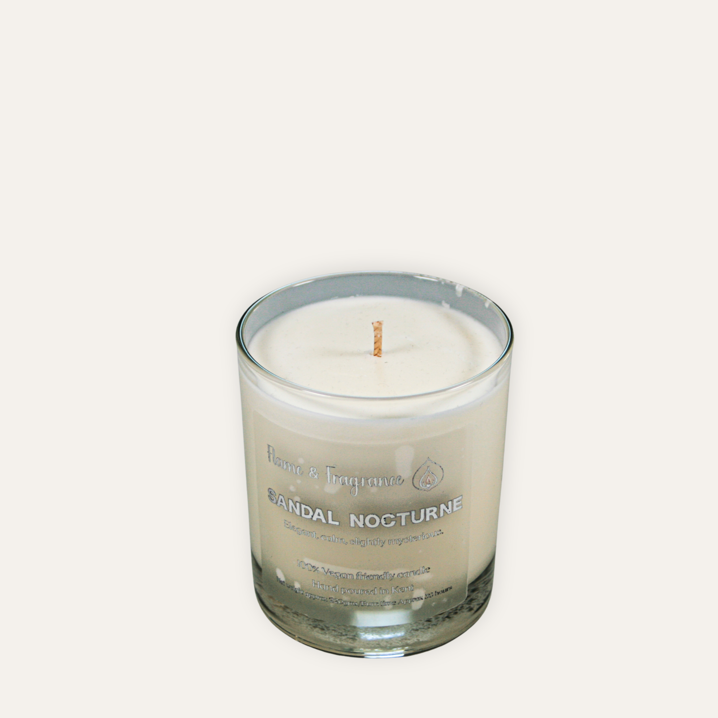 Candle in a glass jar with 'Santal Nocturne' on a white background